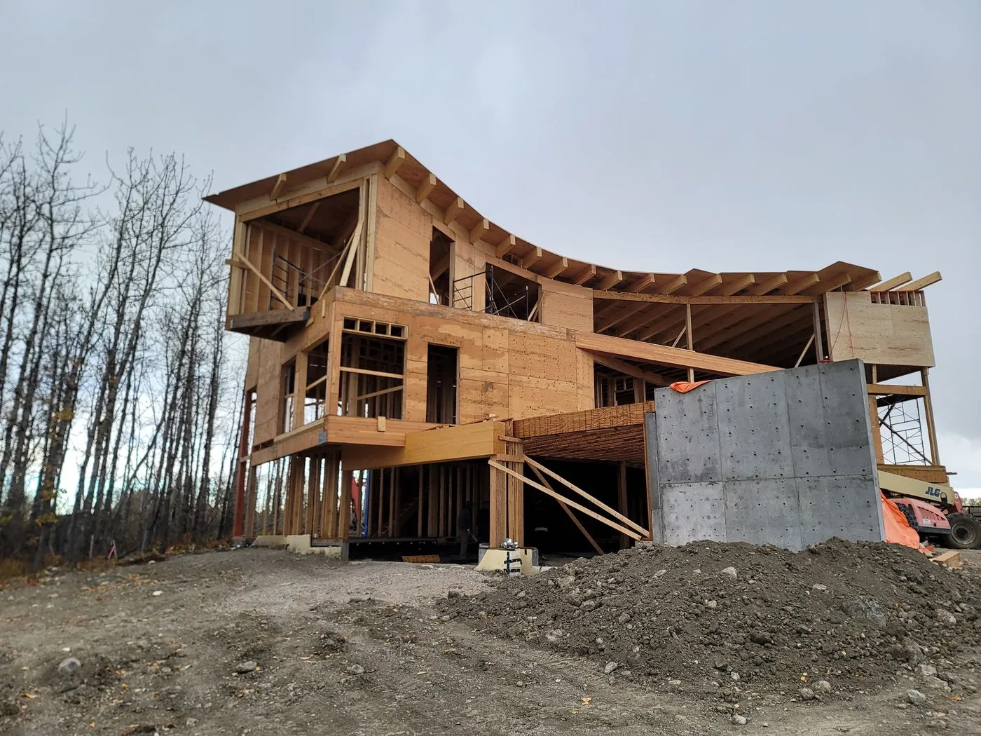 Curved roofline timber framing on construction site