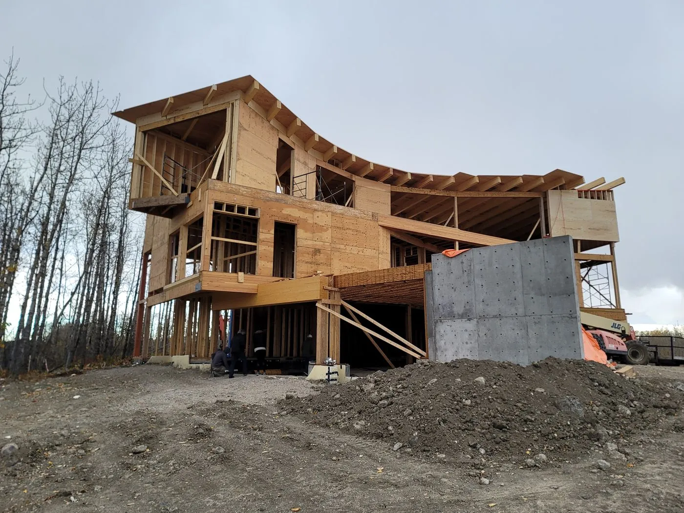 Custom home curved timber roof framing with upper deck
