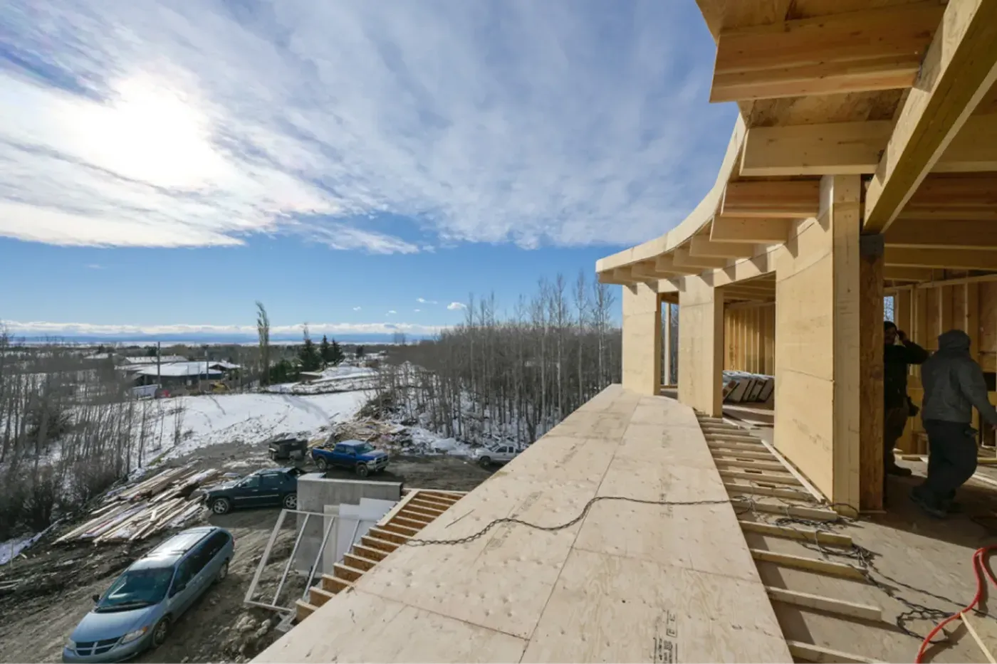 Custom home framing curved soffit overhang aerial view alberta