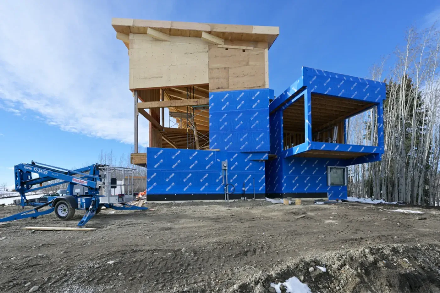 Custom home framing exterior insulation boom lift construction