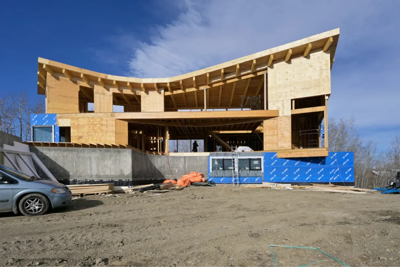 Custom home front elevation with curved roofline framing, Alberta